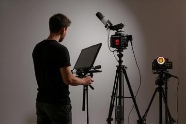 Person setting up equipment for filming.